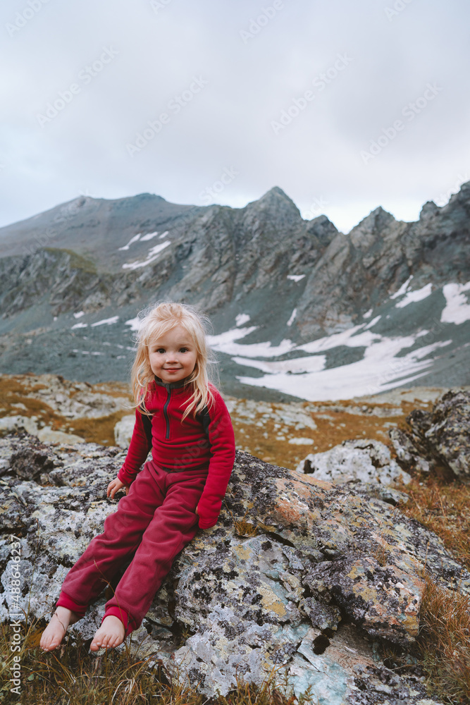Child girl walking in mountains barefoot happy smiling face family vacations hiking trip healthy lifestyle 3 years old toddler outdoor