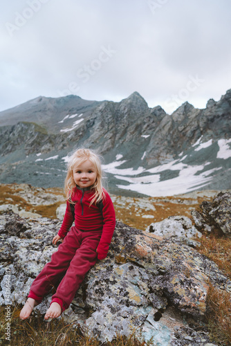 Child girl walking in mountains barefoot happy smiling face family vacations hiking trip healthy lifestyle 3 years old toddler outdoor