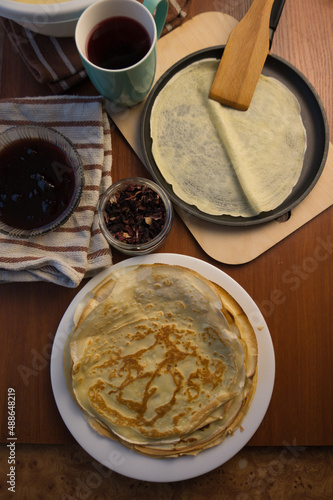 Pancake week. Preparation of dough for baking delicious and ruddy pancakes from the ingredients eggs, flour, butter and milk. Maslenitsa traditional Russian festival meal.