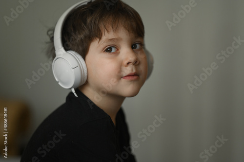 the boy listens to music with headphones 