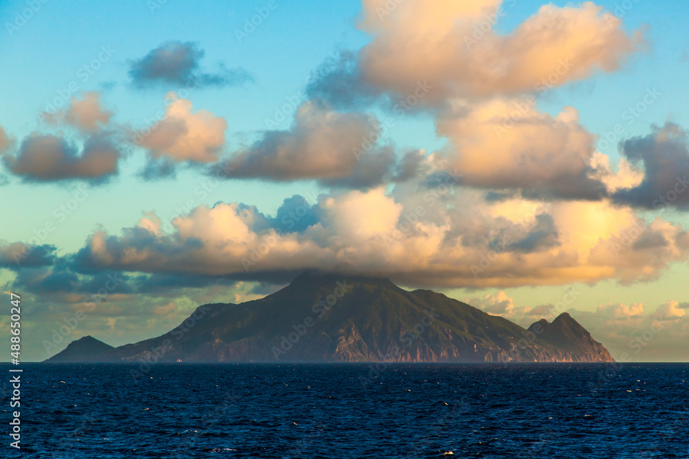 Mountain in the sea and clouds from above. Volcano in the sea off the coast of Italy.