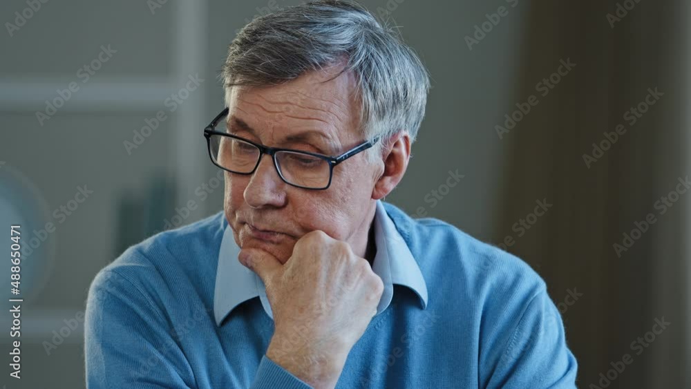 Portrait of pensive upset elderly man thinking health problems feeling unhappy close up middle aged mature old grandfather suffering from depression sad frustrated pensioner in glasses sit alone home Portrait of pensive upset elderly man thinking health problems feeling unhappy close up middle aged mature old grandfather suffering from depression sad frustrated pensioner in glasses sit alone home