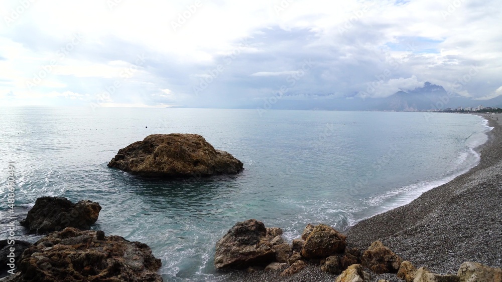 Crystal clear turquoise water, waves crashing on the rocky shore, and the ruins Crystal clear turquoise water, waves crashing on the rocky shore, and the ruins