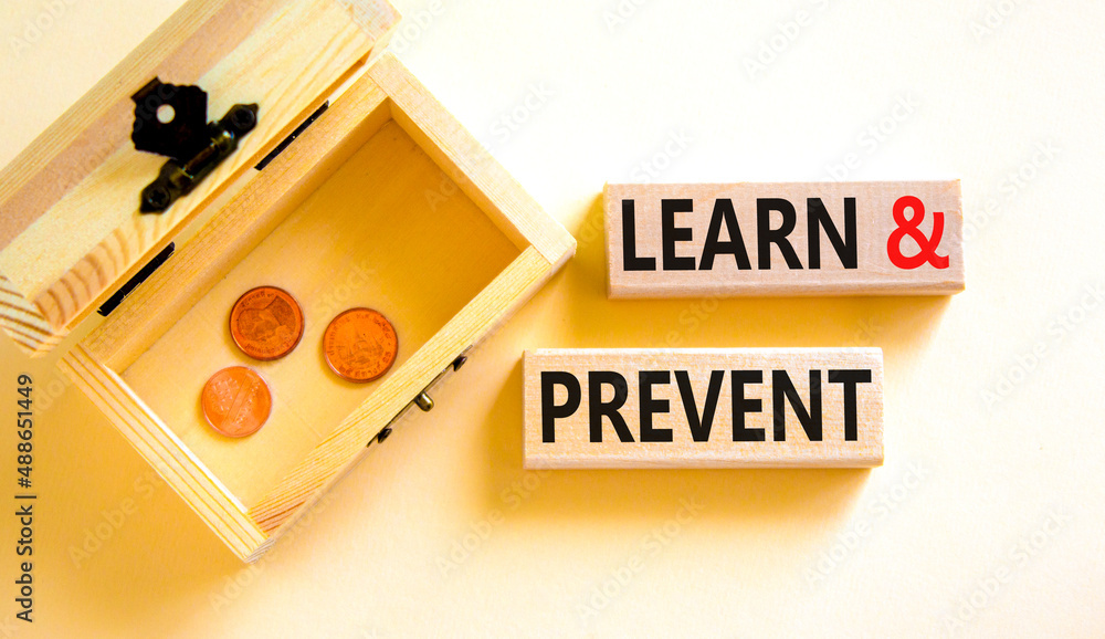 Learn and prevent symbol. Concept words Learn and prevent on wooden blocks on beautiful white background. Wooden chest with coins. Business learning and learn and prevent concept, copy space. Learn and prevent symbol. Concept words Learn and prevent on wooden blocks on beautiful white background. Wooden chest with coins. Business learning and learn and prevent concept, copy space.