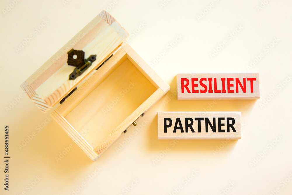 Resilient partner symbol. Concept words Resilient partner on wooden blocks on a beautiful white table white background. Empthy wooden chest. Business resilience resilient partner concept, copy space. Resilient partner symbol. Concept words Resilient partner on wooden blocks on a beautiful white table white background. Empthy wooden chest. Business resilience resilient partner concept, copy space.