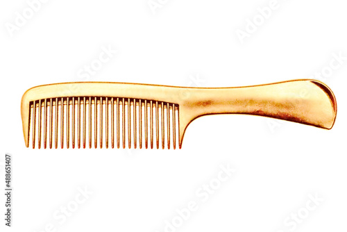 Golden hairbrush on a white isolated background.