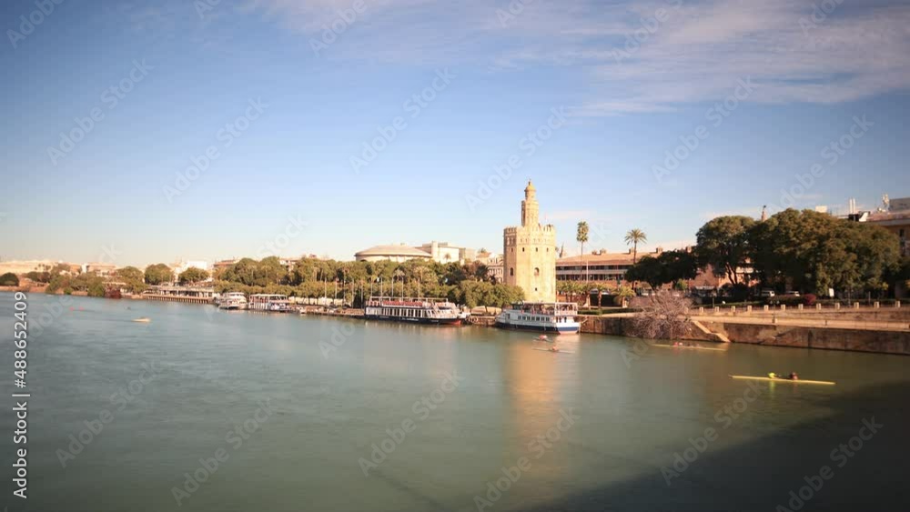 Time lapse of the Guadalquivir river and the Torre del Oro in Seville, Spain. Seville Skyline. Time lapse of the Guadalquivir river and the Torre del Oro in Seville, Spain. Seville Skyline.