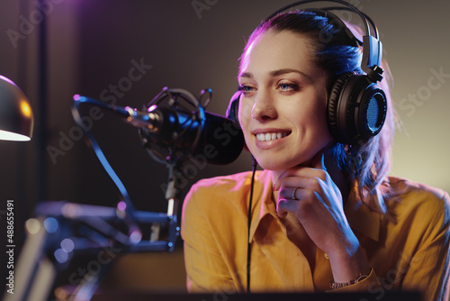 Young woman working at the radio station photo