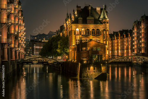 Speicherstadt Hamburg moated castle illuminated in the blue hour.