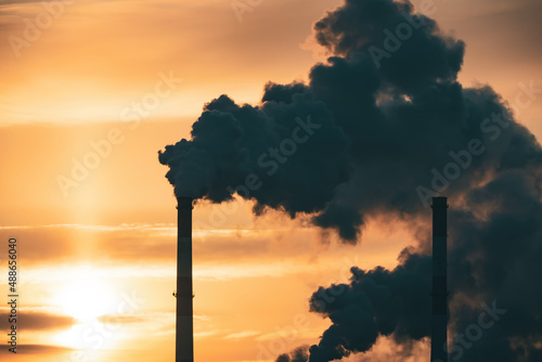 Industrial factory smokestack emission carbon gases and in atmosphere. Industry zone, factory smoke plumes. Climate change, ecology and global warming photo
