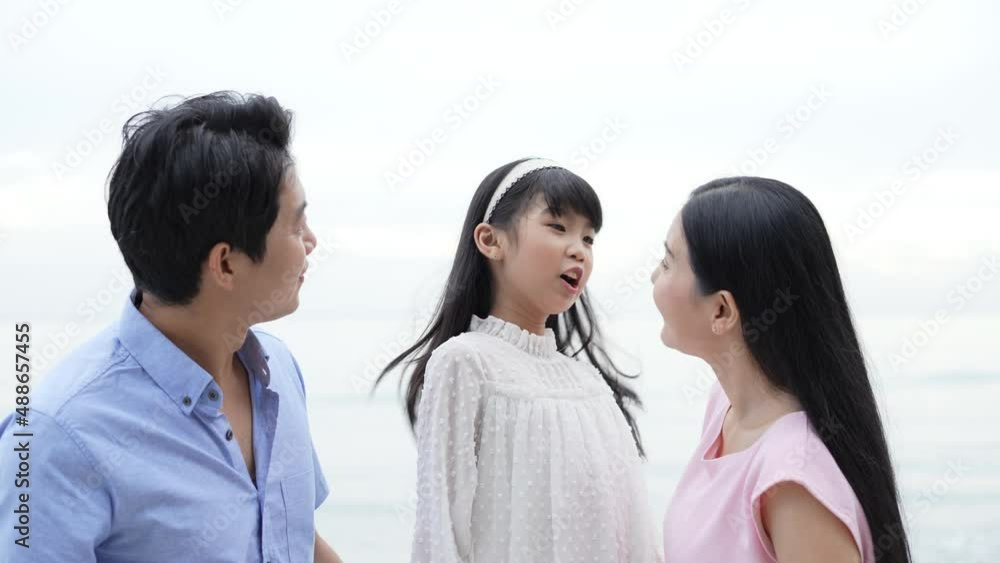 Holiday concept of 4k Resolution. Parents and daughters are watching with smiles by the sea. family relationship. Holiday concept of 4k Resolution. Parents and daughters are watching with smiles by the sea. family relationship.