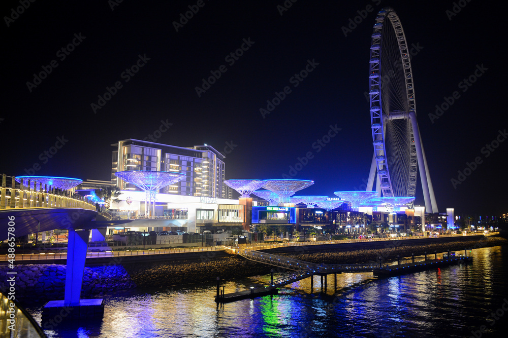 Dubai, UAE - February 3, 2022: Beautiful night view from Bluewaters pedestrian bridge in Marina Walk