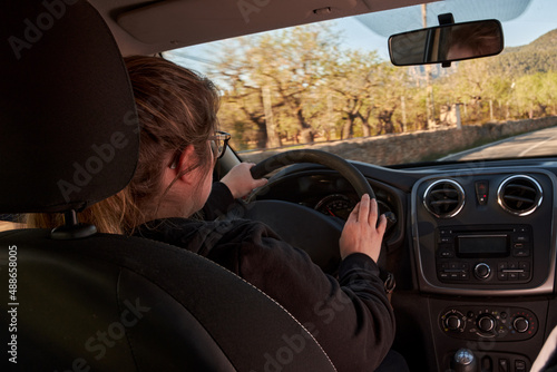 unrecognizable woman driving a car