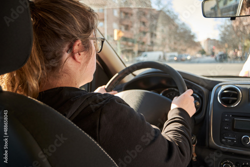 unrecognizable woman driving a car
