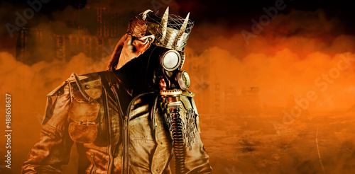 Photo of post apocalyptic warrior with armored outfit jacket, gas mask and crown standing on destroyed city background with orange gas fog. photo