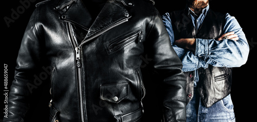 Photo of men in jeans shirt, leather biker vest and jacket standing on black background. Clothing store concept.