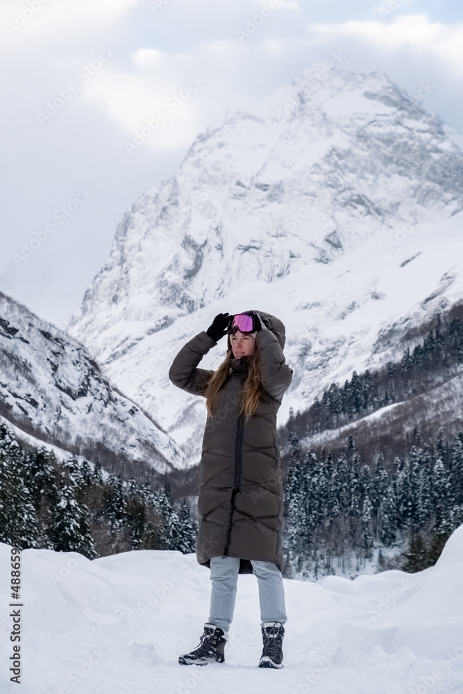 Girl walking in the snowy forest.