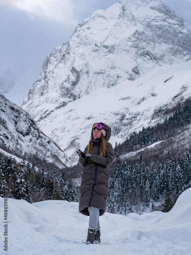 Girl walking in the snowy forest.