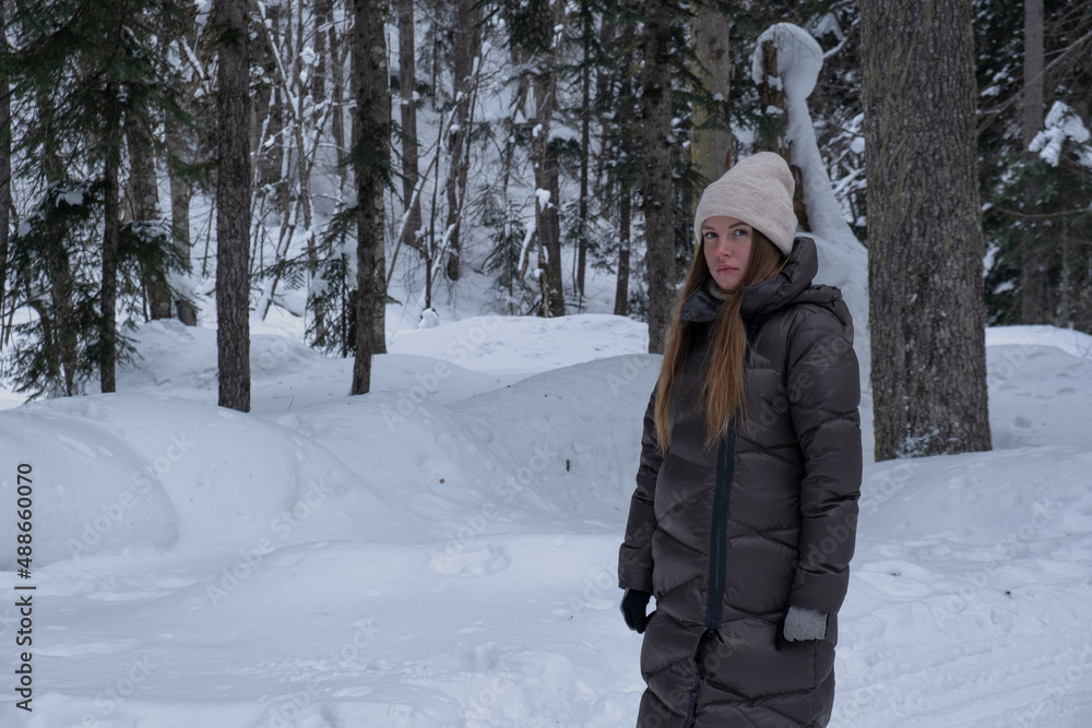 Girl walking in the snowy forest. Girl walking in the snowy forest.