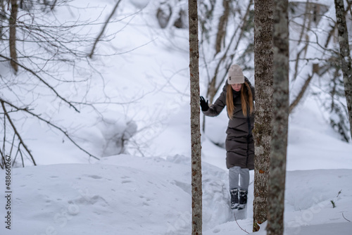 Girl walking in the snowy forest. © Артём Малюков