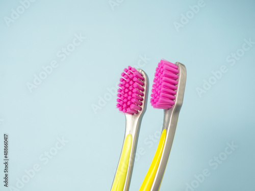 female and male toothbrushes on a blue background with space for text