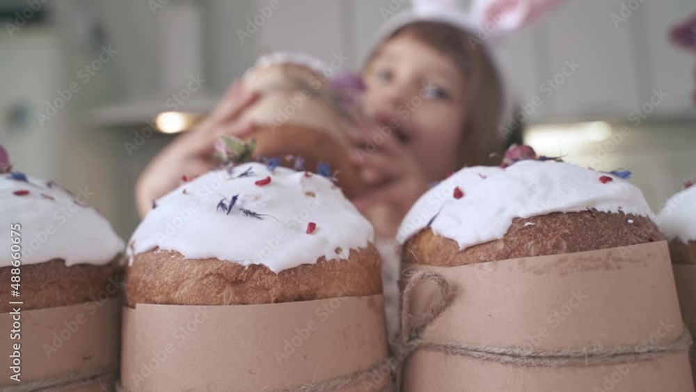 Funny bunny child girl holds an Easter cake in his hands. Happy Easter. Homemade cakes for holidays, healthy food, healthy sweets for children Funny bunny child girl holds an Easter cake in his hands. Happy Easter. Homemade cakes for holidays, healthy food, healthy sweets for children