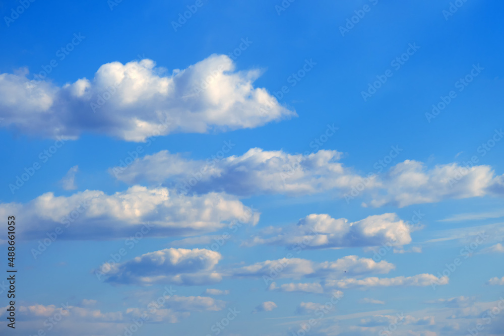 White clouds against a calm blue sky, summer cloudscape White clouds against a calm blue sky, summer cloudscape