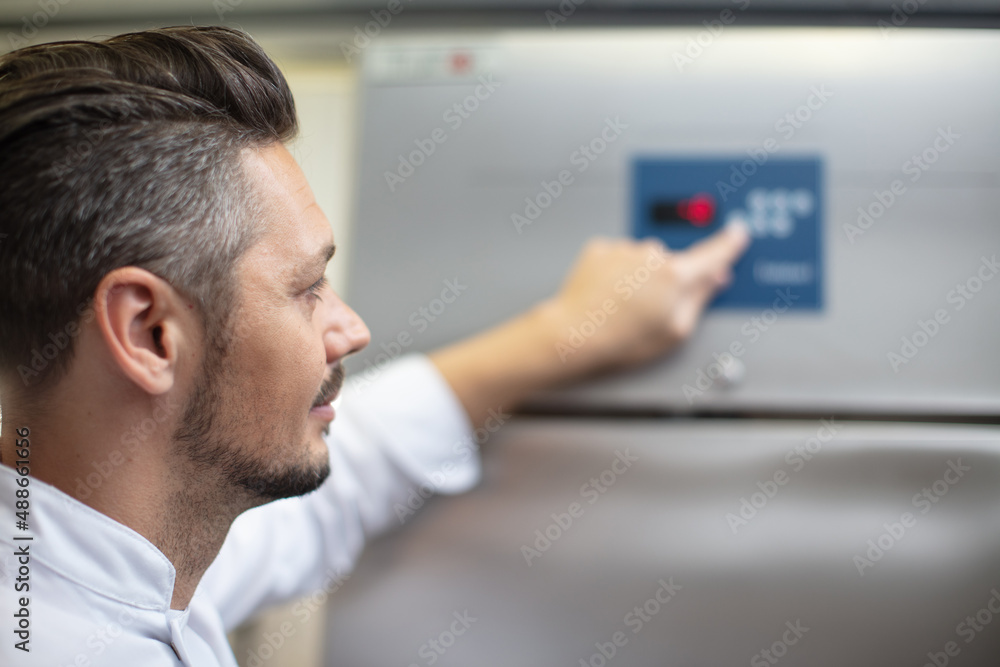 Fototapeta premium portrait of chef cook in uniform standing with ice cream