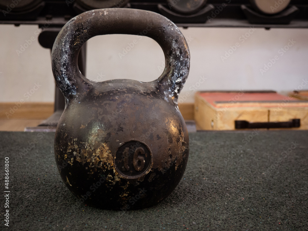 old kettlebell on the floor in the gym .copy space old kettlebell on the floor in the gym .copy space