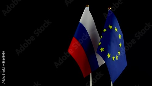 EU and Russia flags on black background. Sanctions pressure, politics concept photo. Europe union vs Russia. Copy space photo