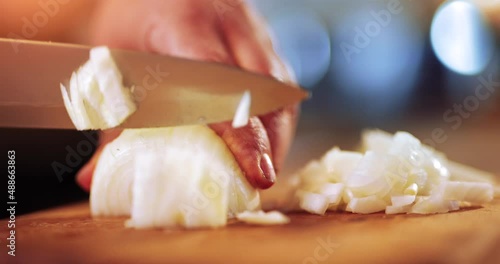 Preparing traditional food, chopping or slicing onion using a knife, slow motion