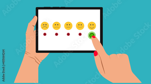 positive rating on the tablet.
happy emoticon selected.Customer service assessment and technology customer support concept.