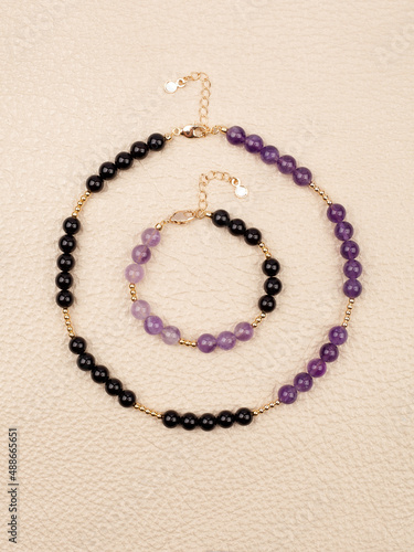 Women`s necklace and bracelet of black and purple gem stones