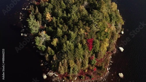 Flying over island populated with deciduous and evergreen trees Lake Katahdin 