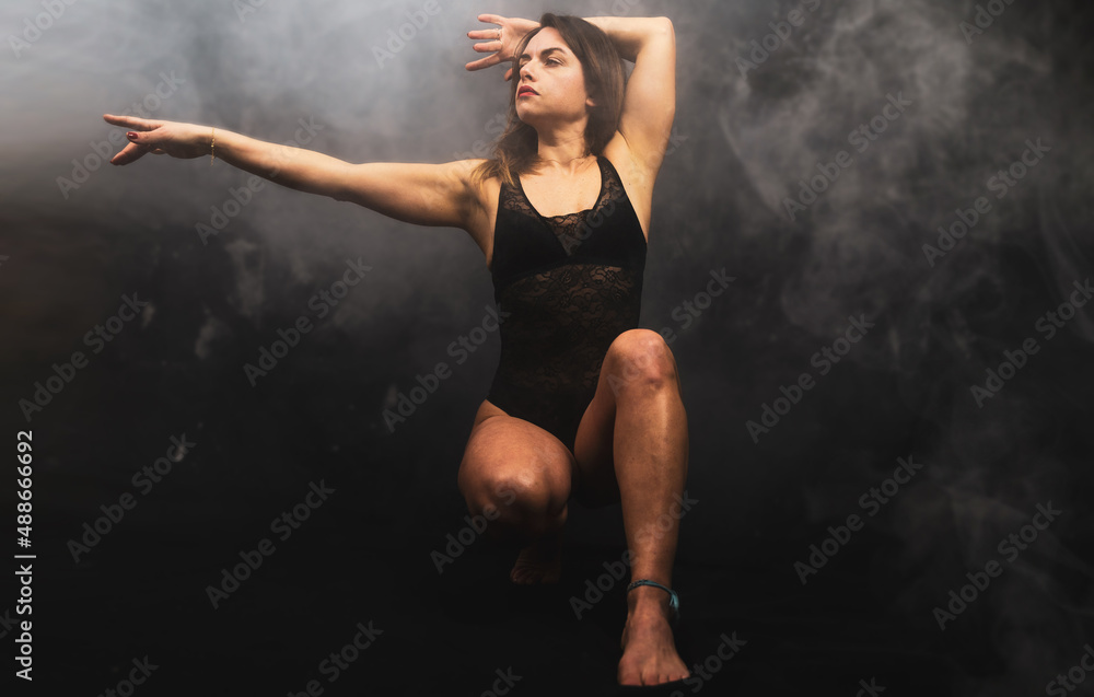 young attractive woman practicing yoga discipline in a foggy room