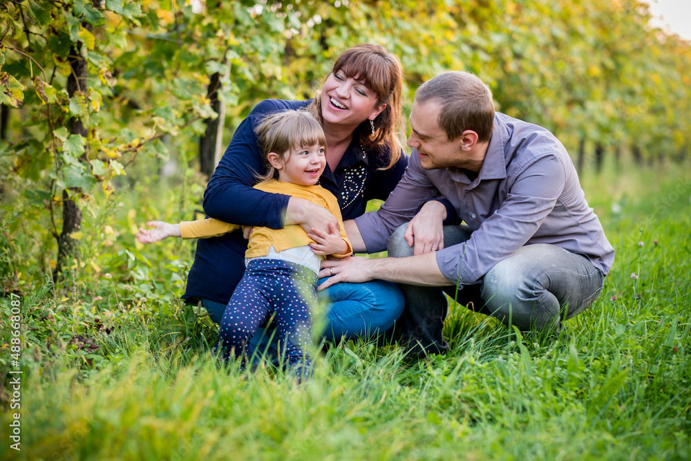 Portrait of happy family having fun together at a vineyard at sunny day Portrait of happy family having fun together at a vineyard at sunny day