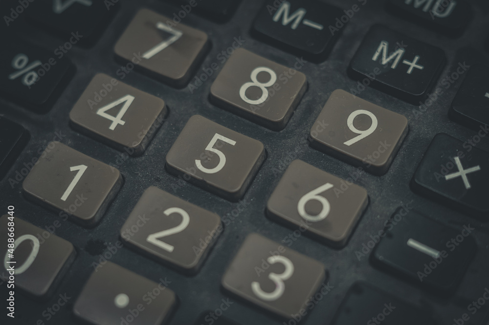 Close-up of an old dusty calculator. Electronic equipment for counting and calculations. Selective focus Close-up of an old dusty calculator. Electronic equipment for counting and calculations. Selective focus
