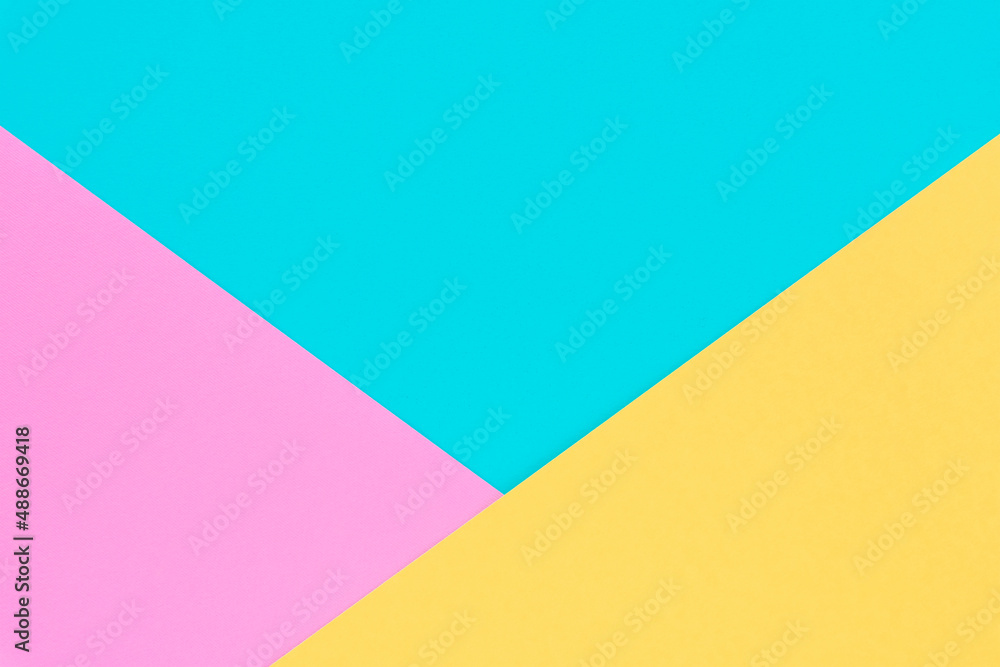 Yellow, pink and blue colored paper. Geometric empty paper background of three tones for copy space Yellow, pink and blue colored paper. Geometric empty paper background of three tones for copy space