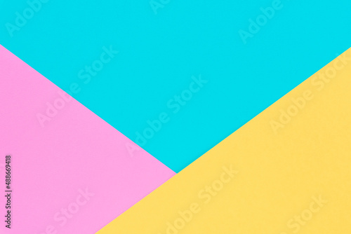 Yellow, pink and blue colored paper. Geometric empty paper background of three tones for copy space