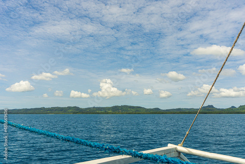 A hilly landscsape from a ship in the water photo