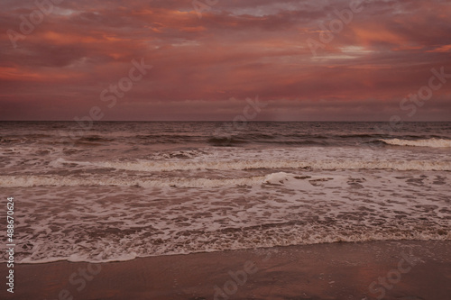Pink Sunset on Beach with Waves