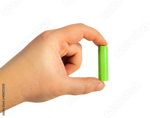 Isolated photo of male hand holding grenn colored rechargeable battery on white background.