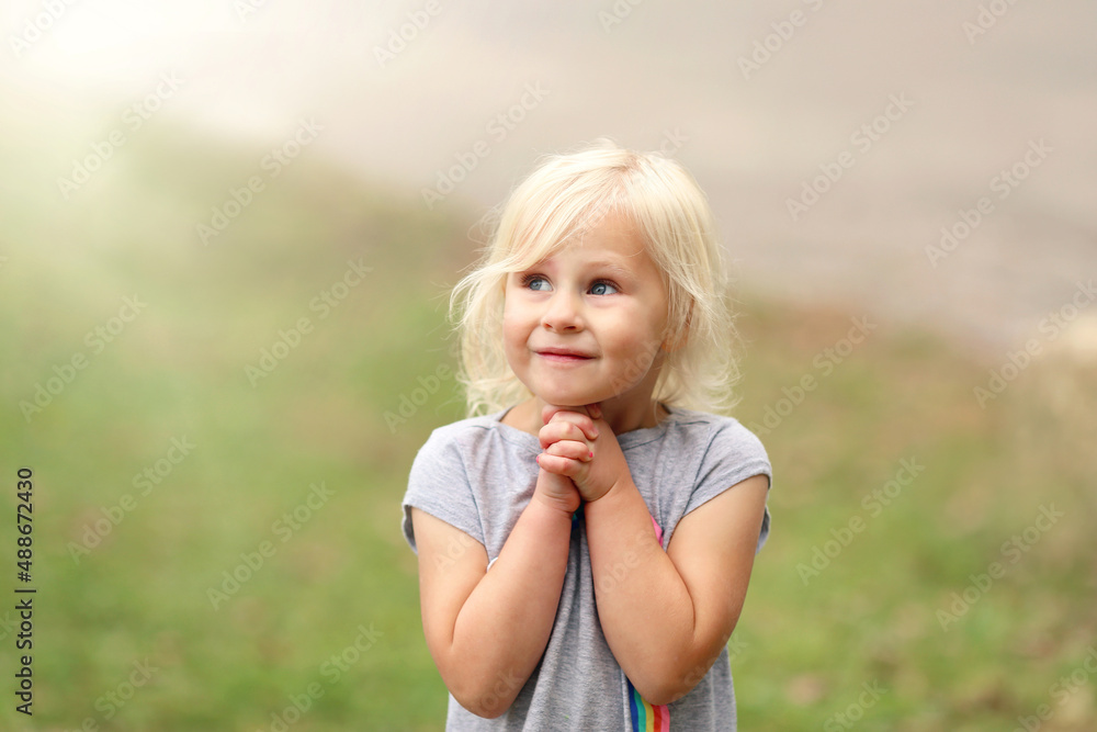 Sweet Little Girl Child Praying Outside on Summer Day. Sweet Little Girl Child Praying Outside on Summer Day.
