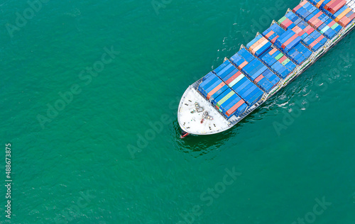 Aerial top view of cargo ship carrying container for import export goods to customer,concept logistic and supply chain