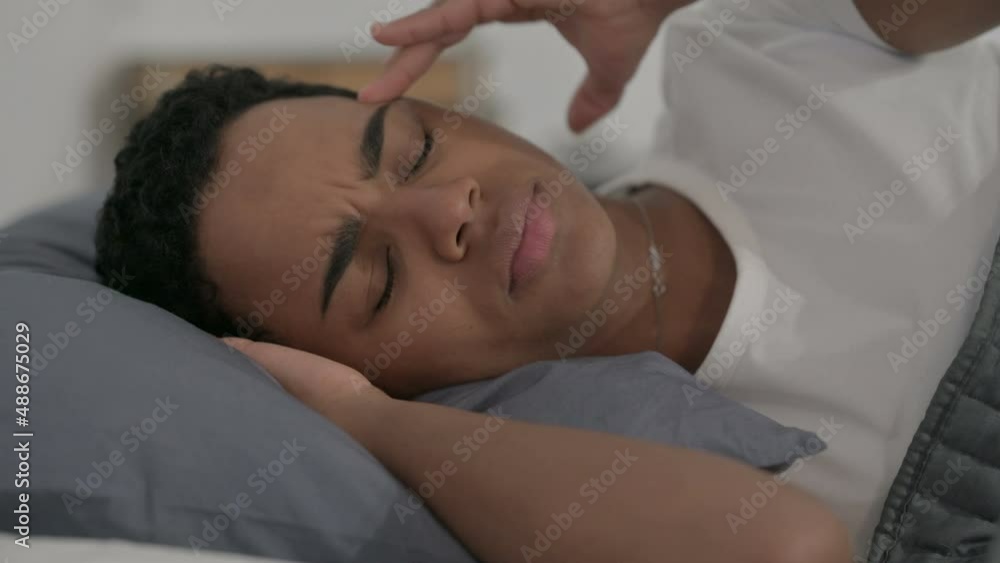 African Woman having Headache while Sleeping in Bed African Woman having Headache while Sleeping in Bed
