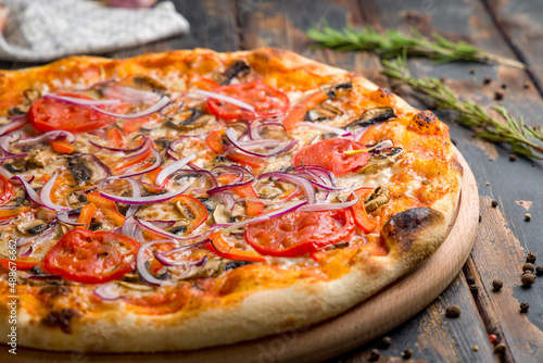 Pizza with vegetables and cheese, vegetarian pizza on old wooden table macro close up