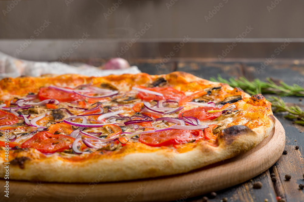 Pizza with vegetables and cheese, vegetarian pizza with steam on old wooden table macro close up Pizza with vegetables and cheese, vegetarian pizza with steam on old wooden table macro close up