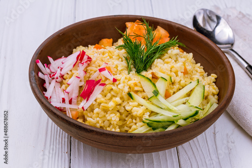 bulgur with vegetables Turkish cuisine on white wooden table