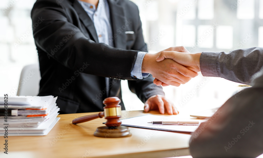 Legal law, advice and justice, Business people and lawyers shaking hands discussing contract agreement, law advice, legal services concepts. Legal law, advice and justice, Business people and lawyers shaking hands discussing contract agreement, law advice, legal services concepts.