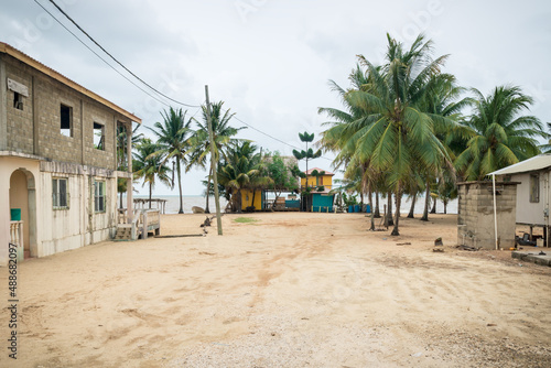 Sand path to local beach bar at Caribbean ocean in Hopkins, Belize photo